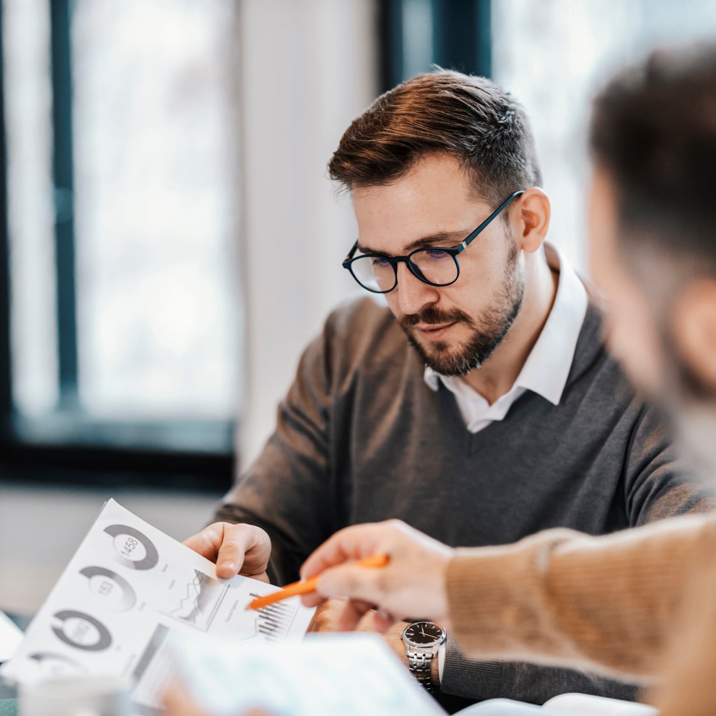 Business professional reviewing financial and performance documents