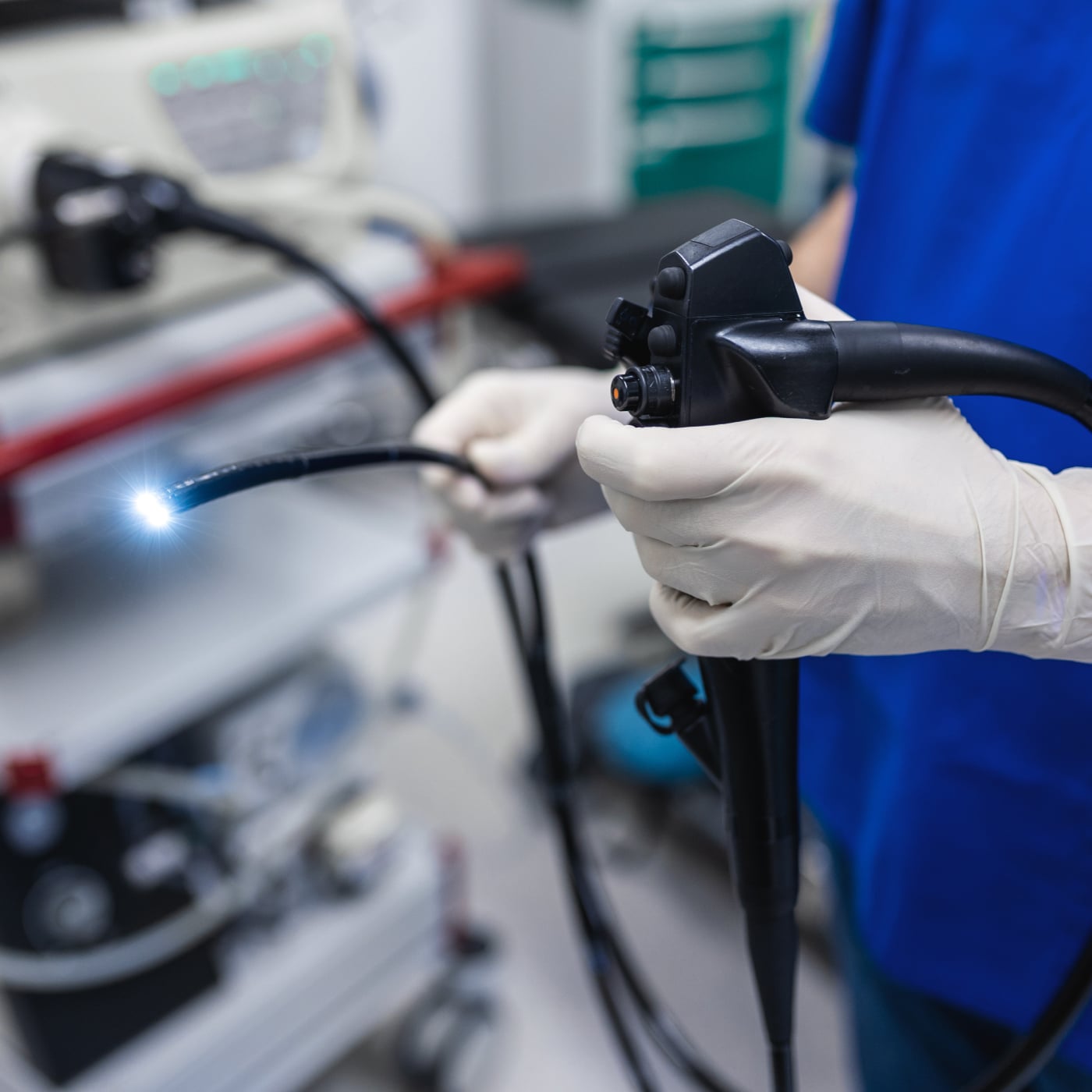 Medical professional preparing endoscopy equipment in a clinical environment