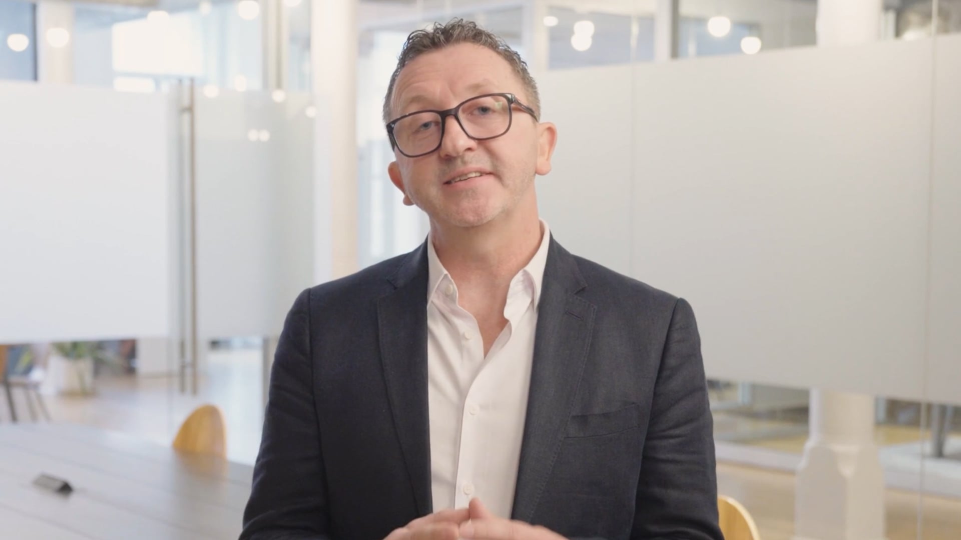 Executive speaking in office setting