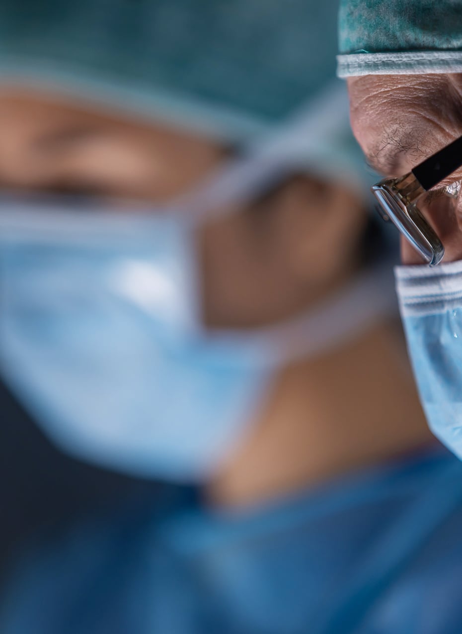 Clinician in medical mask focusing on patient care